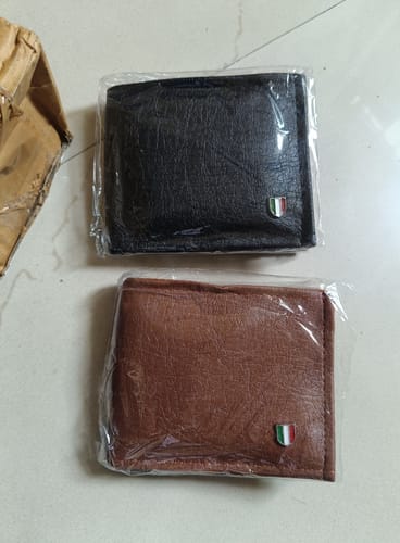 Customer's two wallets, one black and one brown, each with a small shield badge.