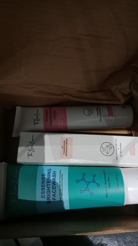 Customer's All Glow Pigmentation Bundle including face wash, pigmentation cream, and lip cream tubes inside a box.