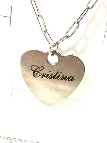 Customer's AtomStack P1 laser module, showcasing a heart-shaped silver necklace engraved with the name Cristina.