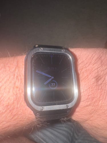 Customer's Apple Watch Ultra with the silver steel modification kit and protective casing worn on their wrist.