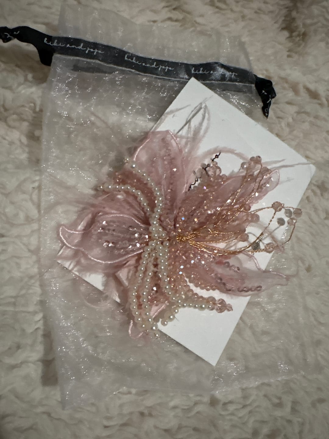 Customer photo review of Blush Hand-Beaded Lily Feather Hair Clip