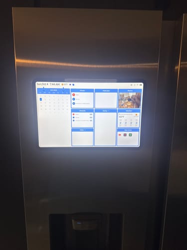 Customer's Everblog FridgeCal mounted on a silver stainless steel refrigerator, displaying a digital calendar interface.