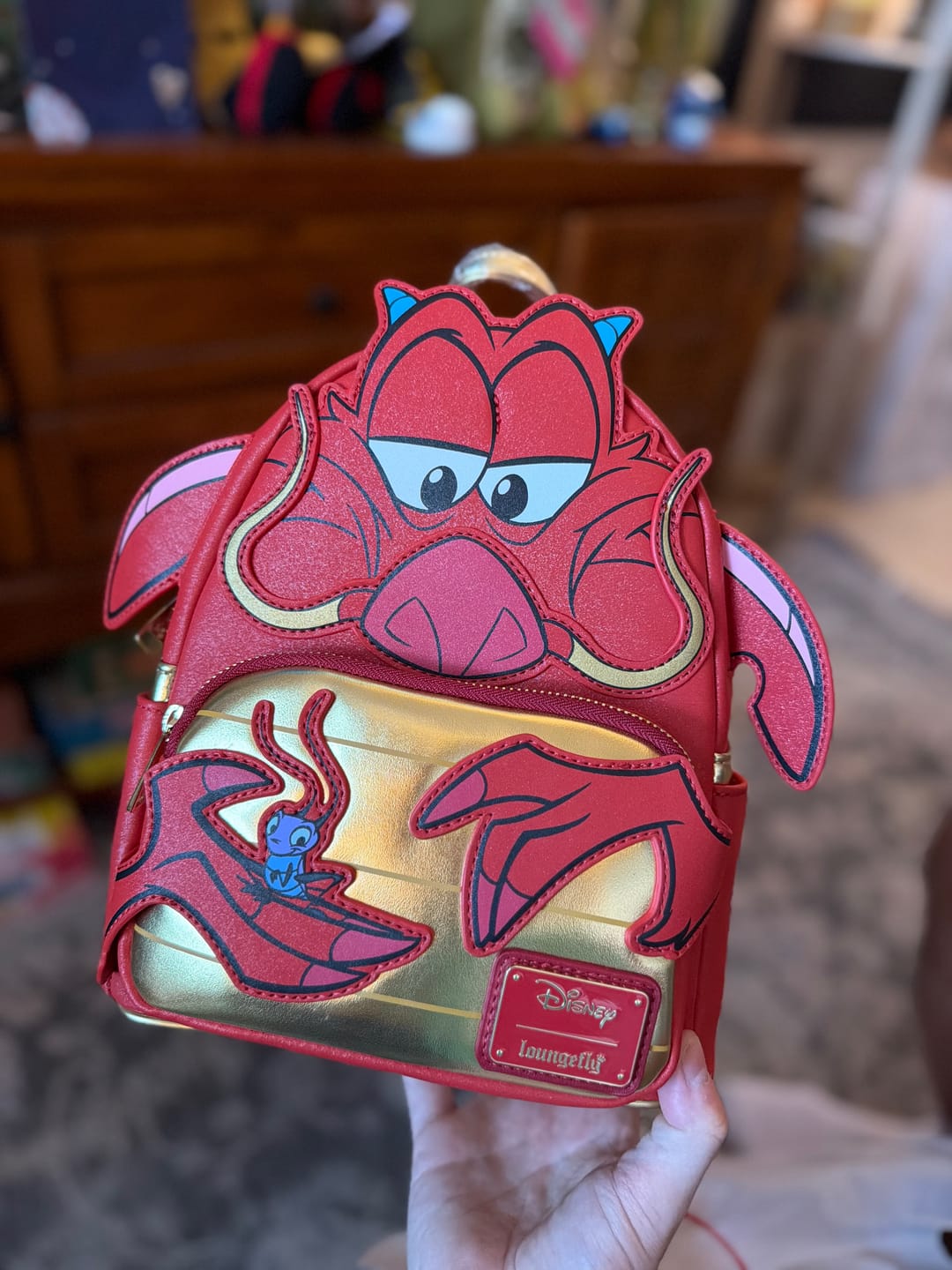 Customer photo review of Loungefly Disney Mulan Mushu Glitter Cosplay Mini Backpack