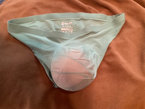 Customer's sagebrush Brushed Nylon Seamless thong, showing pouch design, resting on a soft fabric surface