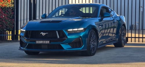 Customer's teal Ford Mustang showing the installed Front SL1 Slimline number plate bracket on the front bumper.