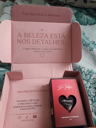 Customer's Attacione Sensual perfume box, open with a heart-shaped product bottle inside on a patterned surface.