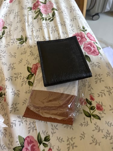 Customer's incorrect plain black and brown wallet received instead of the ordered Spiderman wallet.