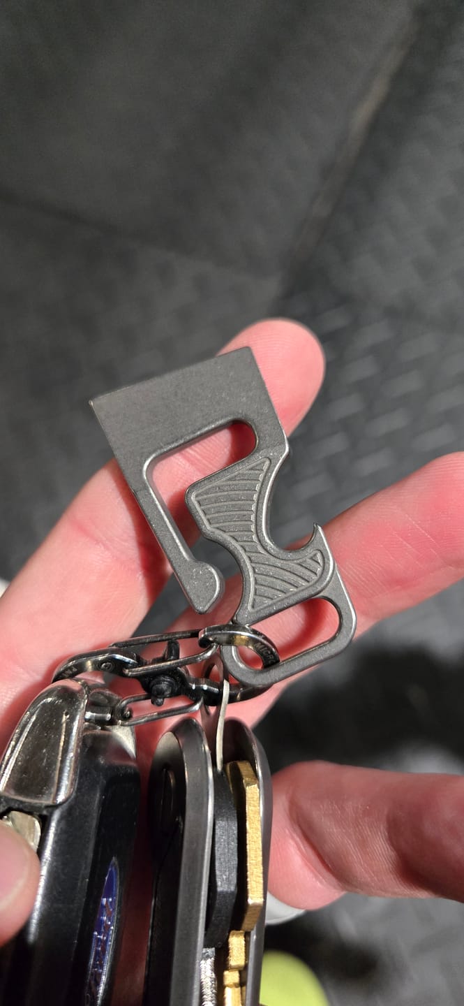 Customer photo review of NGMCo. The Minion 2.05" Titanium Belt Hook Key Clip – Pry, Bottle Opener, 1/4" Wrench, 6Al4V – Made in USA