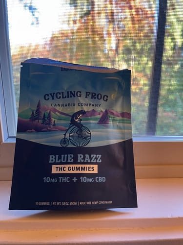 Customer's Blue Razz Gummies packaging sitting on a window sill with a natural background