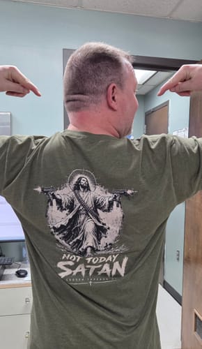 Customer's green Not Today Satan Uzi T-Shirt worn on the back showing a printed graphic of an armed person.