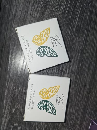 Customer's two Tester Set product boxes featuring yellow and dark green butterfly designs on a wooden surface.