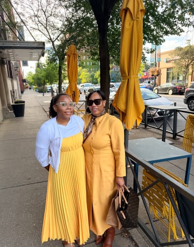 Customer's yellow Maxi Dress standing next to a friend on a sidewalk
