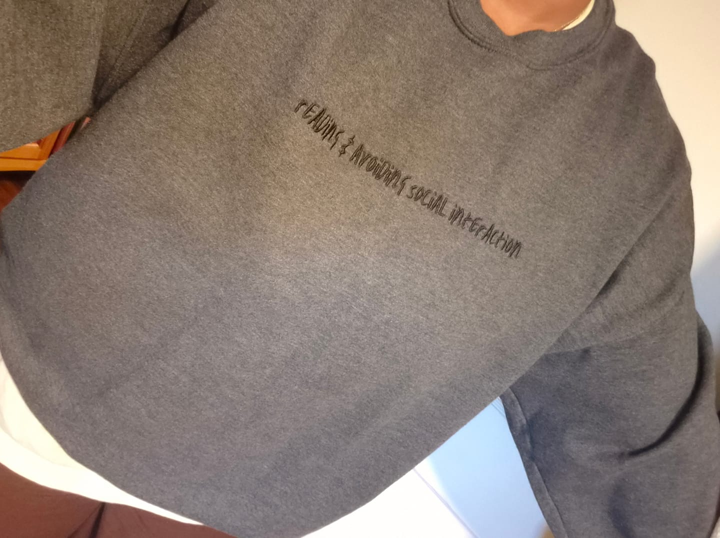 Customer photo review of reading & avoiding social interaction embroidered sweatshirt