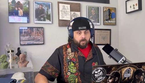 Customer's Monster Safari Vintage Button Up shirt worn by a person wearing a black hat and headphones.