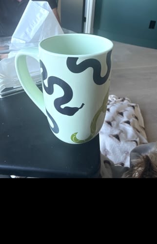 Customer's Sssip Me Green Colour Changing Nordic Mug featuring dark snake designs on a light green ceramic surface.