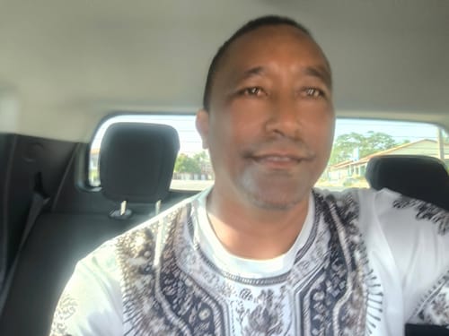 Customer's selfie taken inside a car, reviewing the Attracione Men perfume.