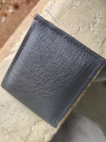 Customer's plain, textured dark grey Spiderman wallet showing the exterior surface close-up.