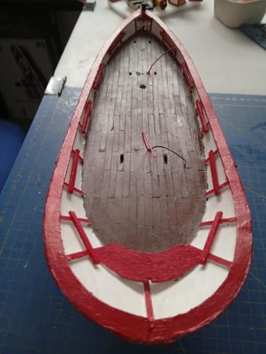 Customer's Palamós model boat, top-down view showing red trim on the deck edges.