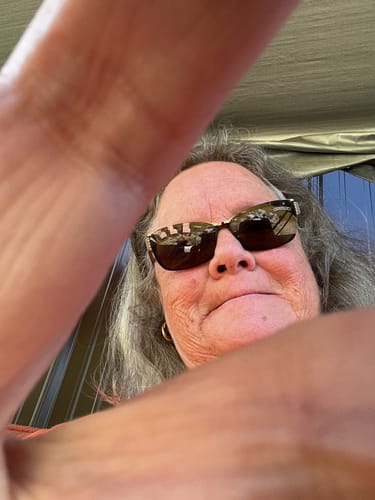 Reviewer wearing sunglasses, selfie-style, after taking XXXtreme Gummies to help with pain.