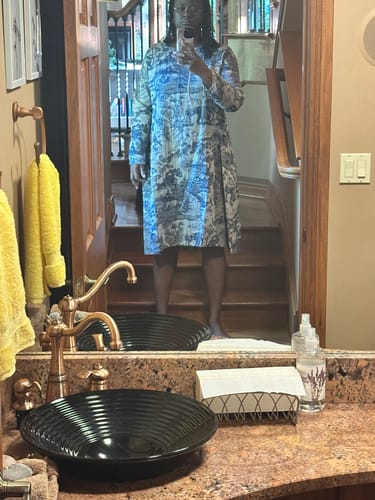 Customer's vintage toile print maxi dress with long sleeves in a bathroom mirror reflection.