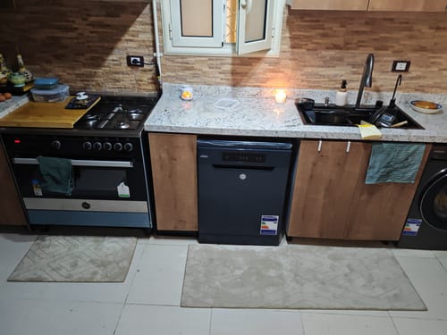 Customer's Radella Kitchen Mat Set featuring two beige rectangular mats laid on the kitchen floor.