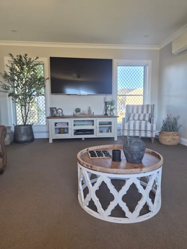 Customer's Beatrice French Provincial Coffee Table with wood top and white lattice base in a sunlit living room.