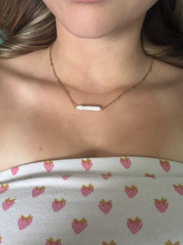Customer's Helios Pearl Necklace worn as a choker, showing the gold satellite chain and irregular natural pearl.