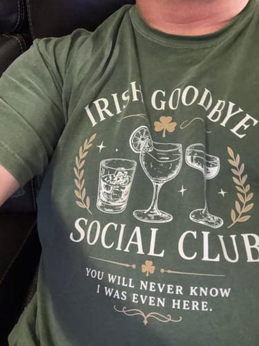 Customer's green Irish Goodbye Club T-Shirt featuring cocktail illustrations and club text.