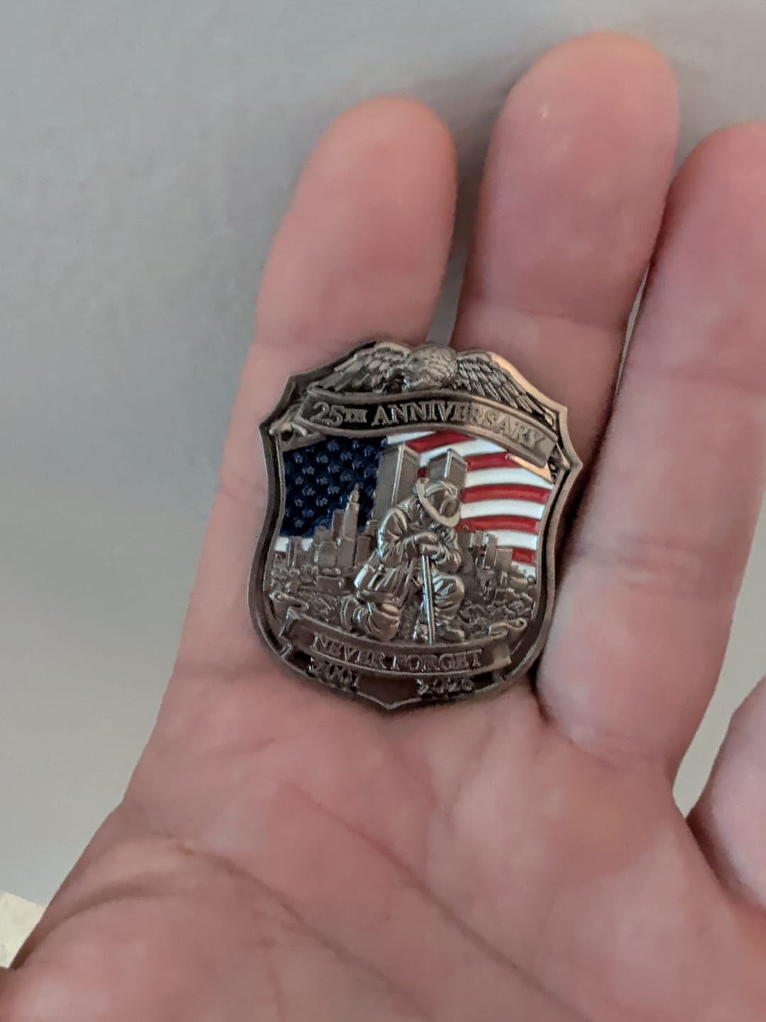 Customer photo review of Never Forget 25th Anniversary 9/11 Firefighter Shield Pin