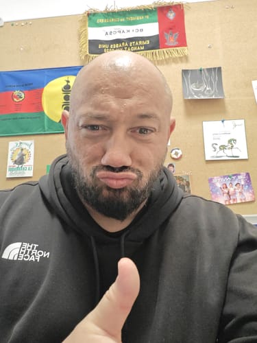 Customer's selfie showing a happy reviewer in a black hoodie.