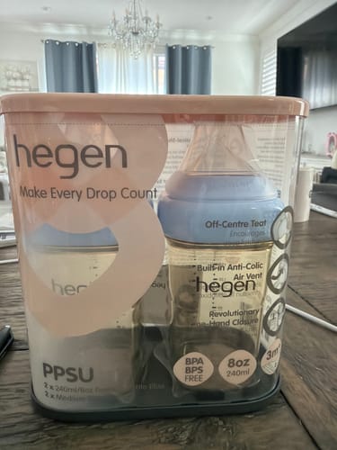 Customer's Hegen PPSU Anti-Colic Baby Bottle 2-pack in clear, sealed retail packaging on a wooden table.