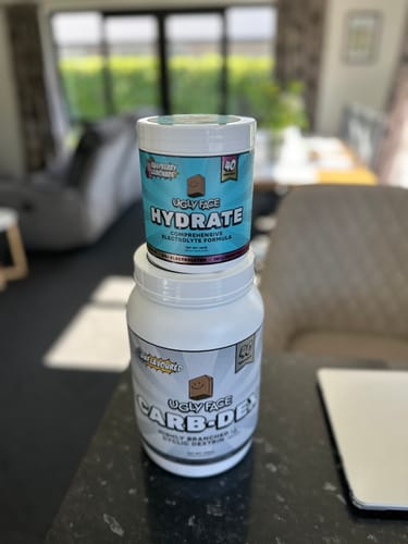Customer's UGLYFACE HYDRATE tub stacked on top of an UGLYFACE CARB-DEX tub on a kitchen counter.