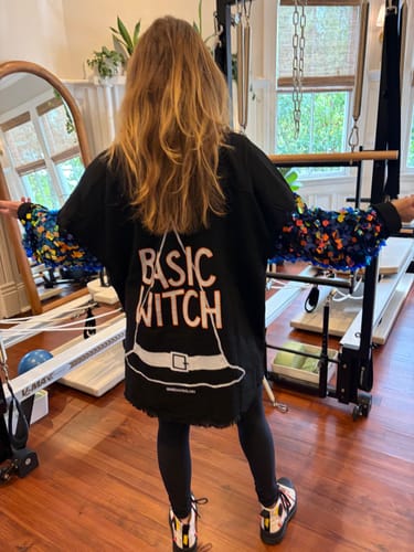 Customer's Basic Witch black denim shaket with colorful embellished sleeves showing the painted text on the back.