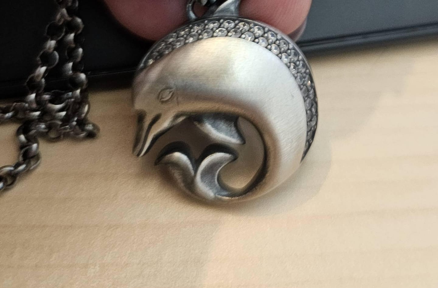 Customer photo review of Curved Dolphin Pendant