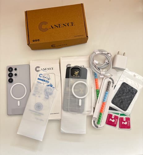 Customer's Anti Yellow Magsafe Clear Case for iPhone 15 Pro Max displayed with its packaging and various free accessories.