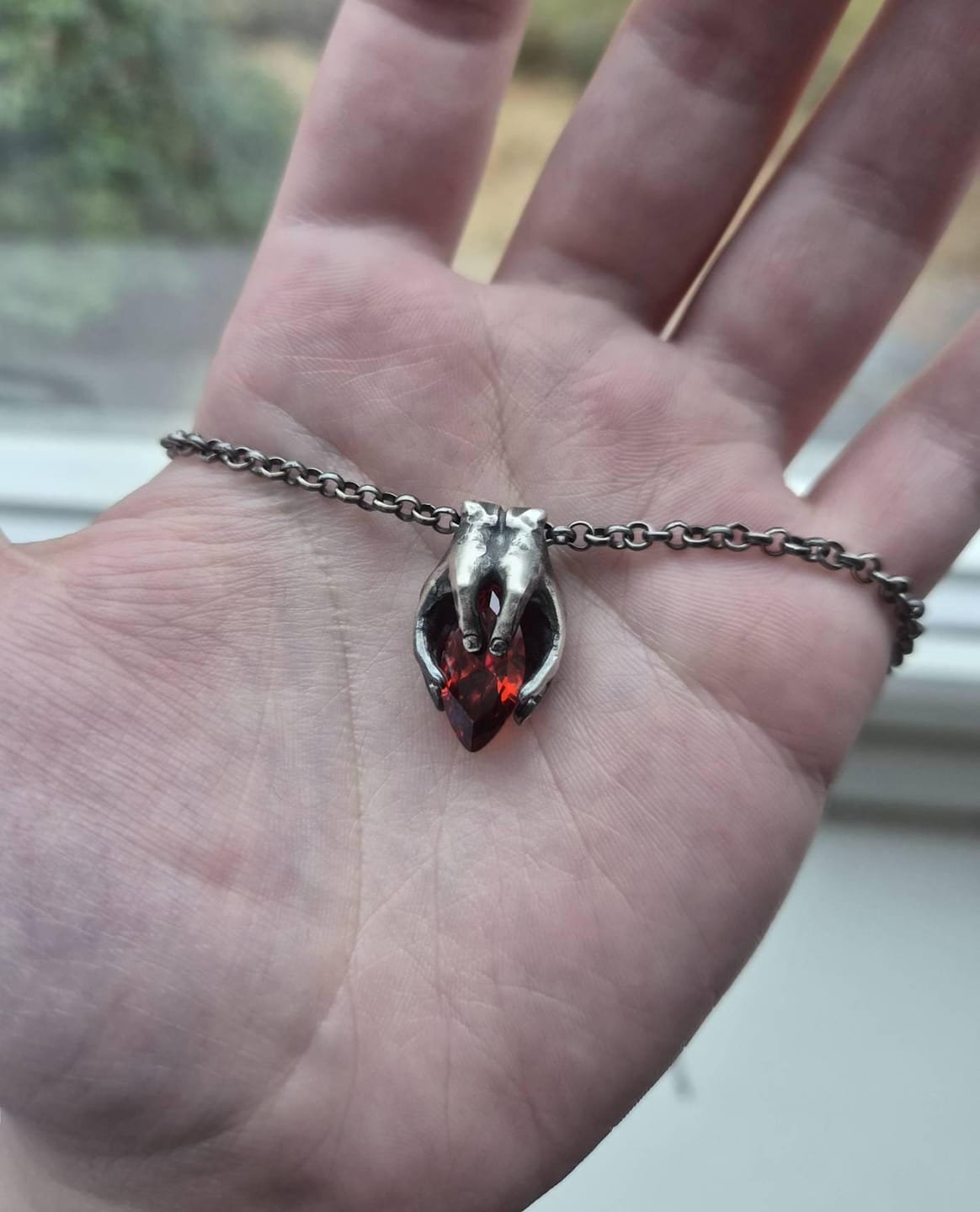 Customer photo review of Hands Garnet Pendant