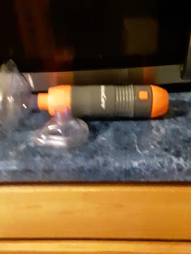 Customer's Universal Guide Tube and clear mask attachments resting on a dark surface.