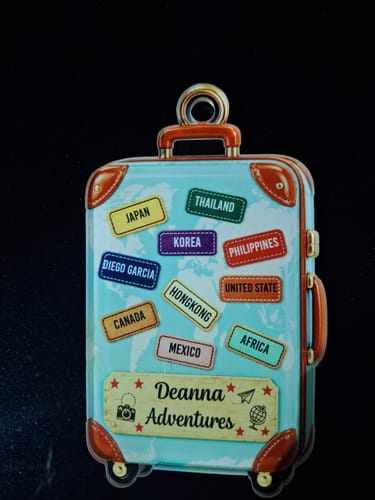 Reviewer's Suitcase Travel World Map ornament with custom 'Deanna Adventures' text and destination labels.