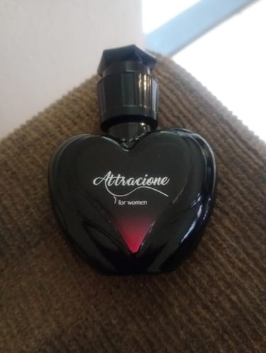 Reviewer's Perfume Attracione Feminino in a black, heart-shaped glass bottle.