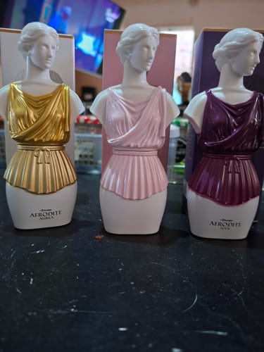 Customer's three Kit Afrodite statues in gold, light pink, and dark purple standing on a counter.