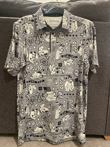 Customer's Pluto All-Day Polo on a hanger, highlighting the all-over black and white character design.