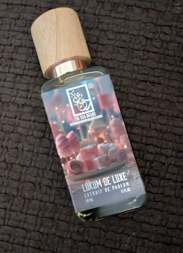 Customer's bottle of Lokum de Luxe perfume, showing its wooden cap and label with sweet confections.