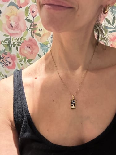 Reviewer wearing the Golden Fortune Necklace, showing the gold and black 'The Moon' tarot card pendant on their chest.