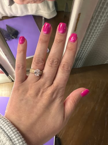 Customer's hand wearing the Silicone Ring, featuring a tan band and a large oval-cut stone.