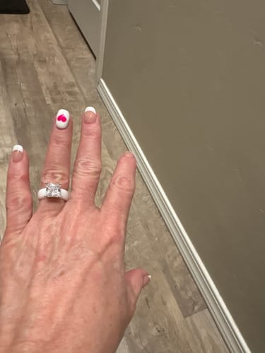 Reviewer's hand wearing the white Silicone Ring with its large princess-cut stone.