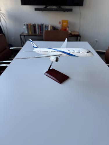 Reviewer's SKYMARKS EL AL 787-9 model airplane on its wooden display stand, shown on a white table.