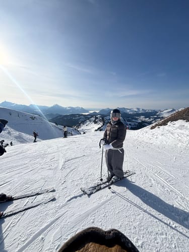 Reviewer on a sunny ski slope wearing the baggy coffee snow pants.