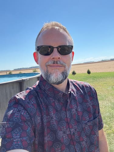 Reviewer wearing the patterned Star Wars 'Dia de los Vaders' shirt outdoors on a sunny day.