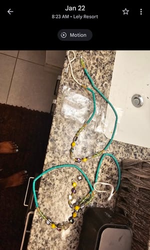 Customer's broken teal waist beads shown in multiple pieces on a granite counter.