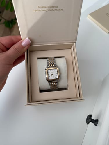 Customer opens the presentation box, showing the elegant Macy Gold Silver watch inside.